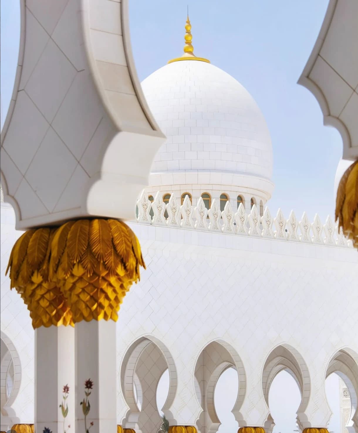 White domes and gilded columns of the Sheikh Zayed Grand Mosque in Abu Dhabi