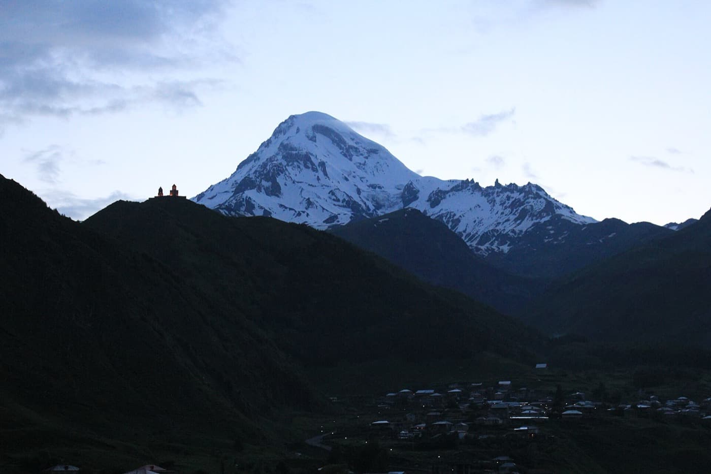 Gergeti Trinity Church on its hilltop below Mount Kazbek