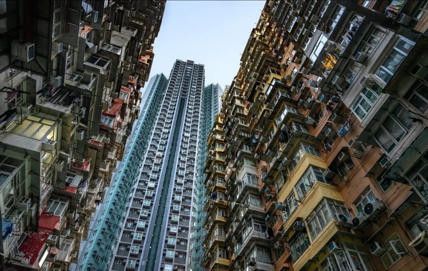 Looking up between the dense residential towers of Quarry Bay, Hong Kong